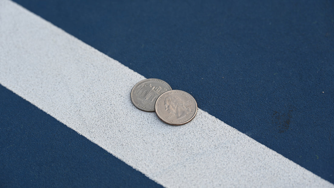 Two quarters on the line of a tennis court