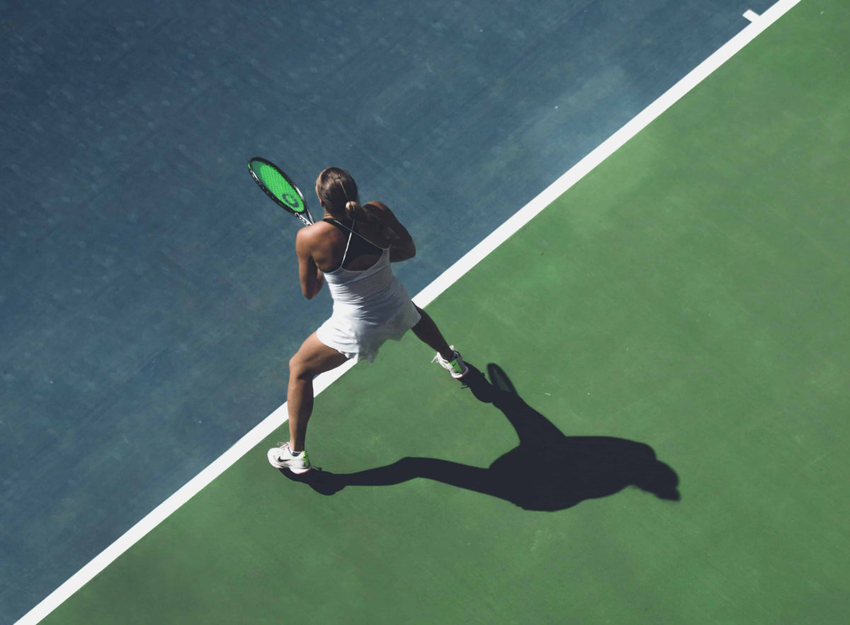 Woman ready to receive serve at baseline