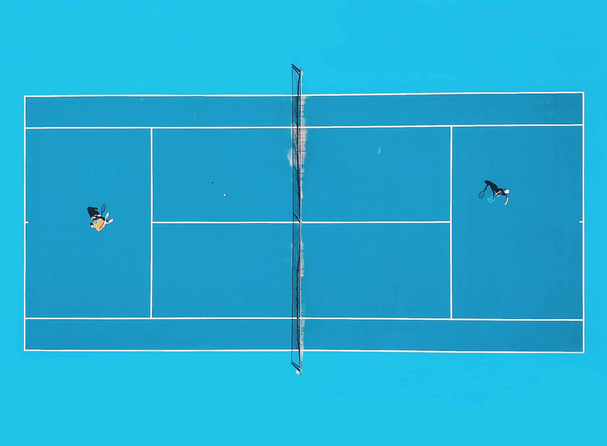 Tennis match on an aqua blue court.