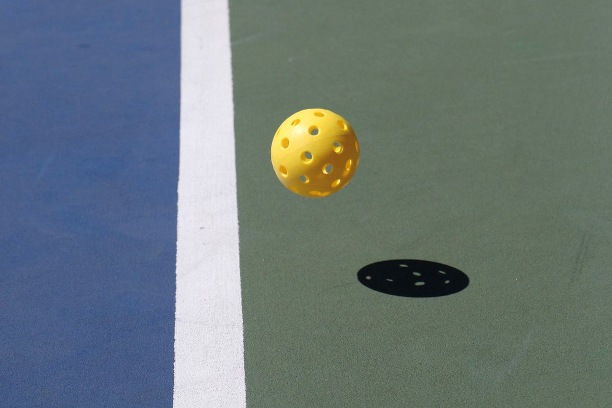 Pickleball in motion near the line