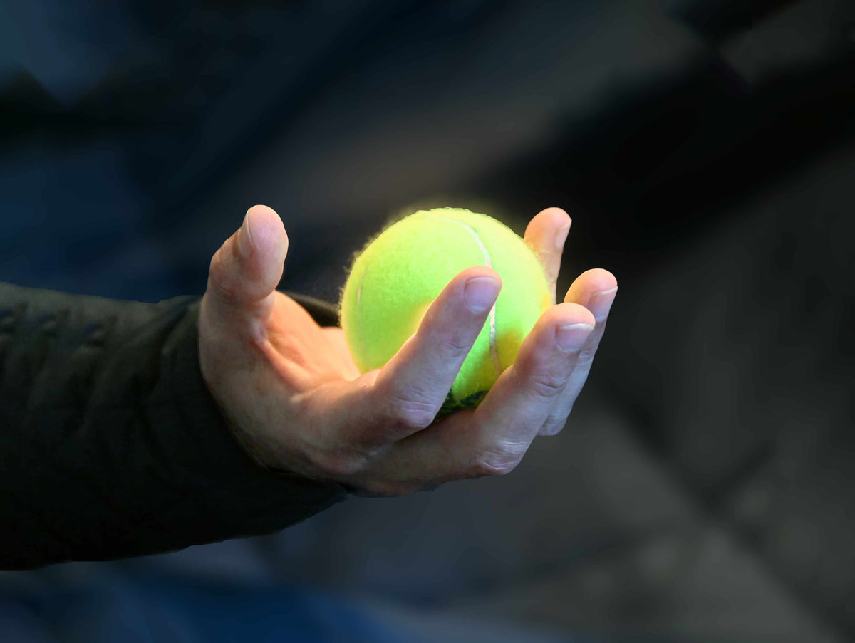 Tennis ball in someone's hand