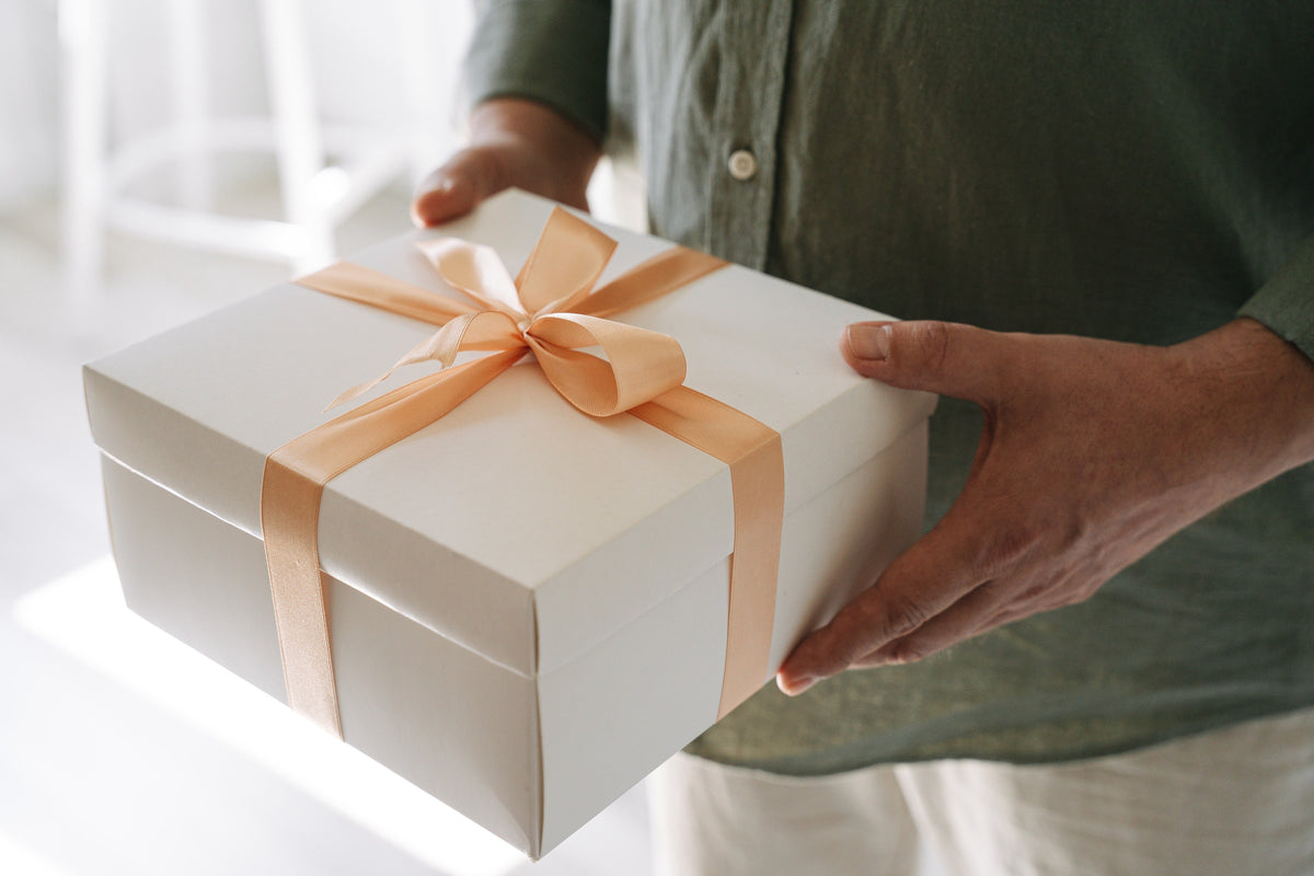 White gift box with a peach bow