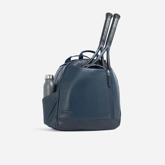 Dark blue tennis bag with two racquets in the main compartment and a silver water bottle in the side pocket.