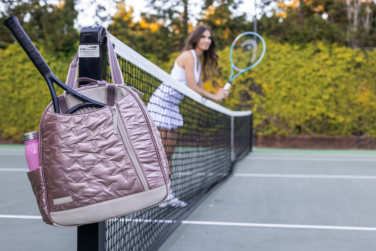 tennis bag with racquet on a tennis court