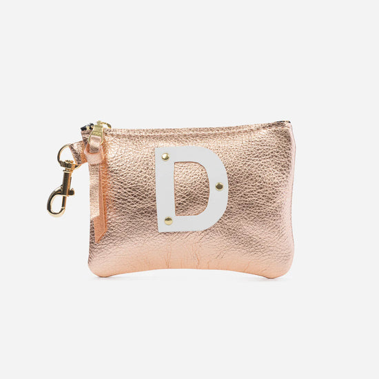 Doubetake's rose gold Shay pouch with D initial in the front
