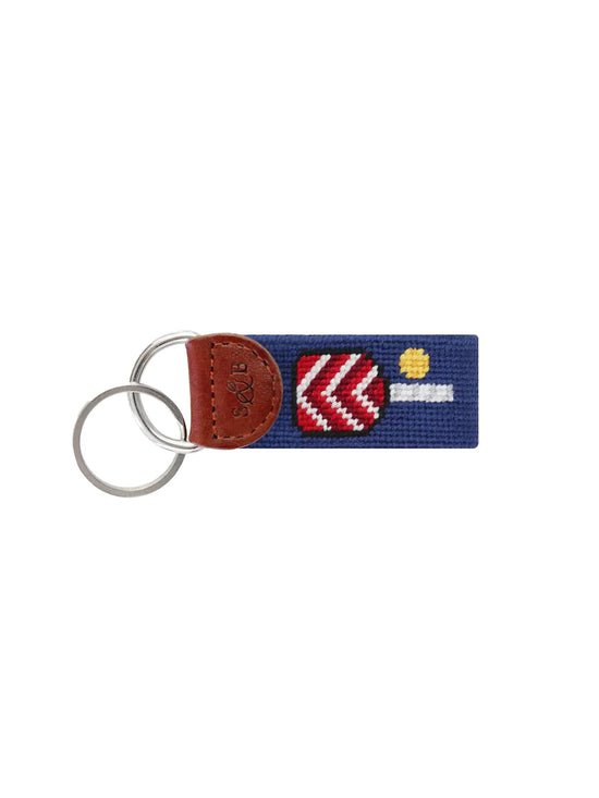 Key fob with brown leather tab, two metal rings, and a blue fabric strap featuring a red and white heart design.