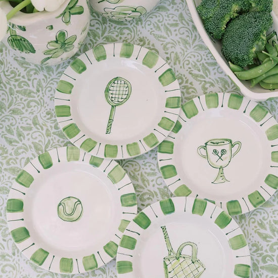 4 painted green plates each with a tennis motif