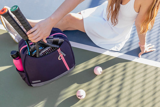 Woman sitting on court with Melbourne tennis bag from Doubletake