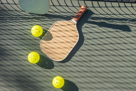 pickleball paddle and balls on court