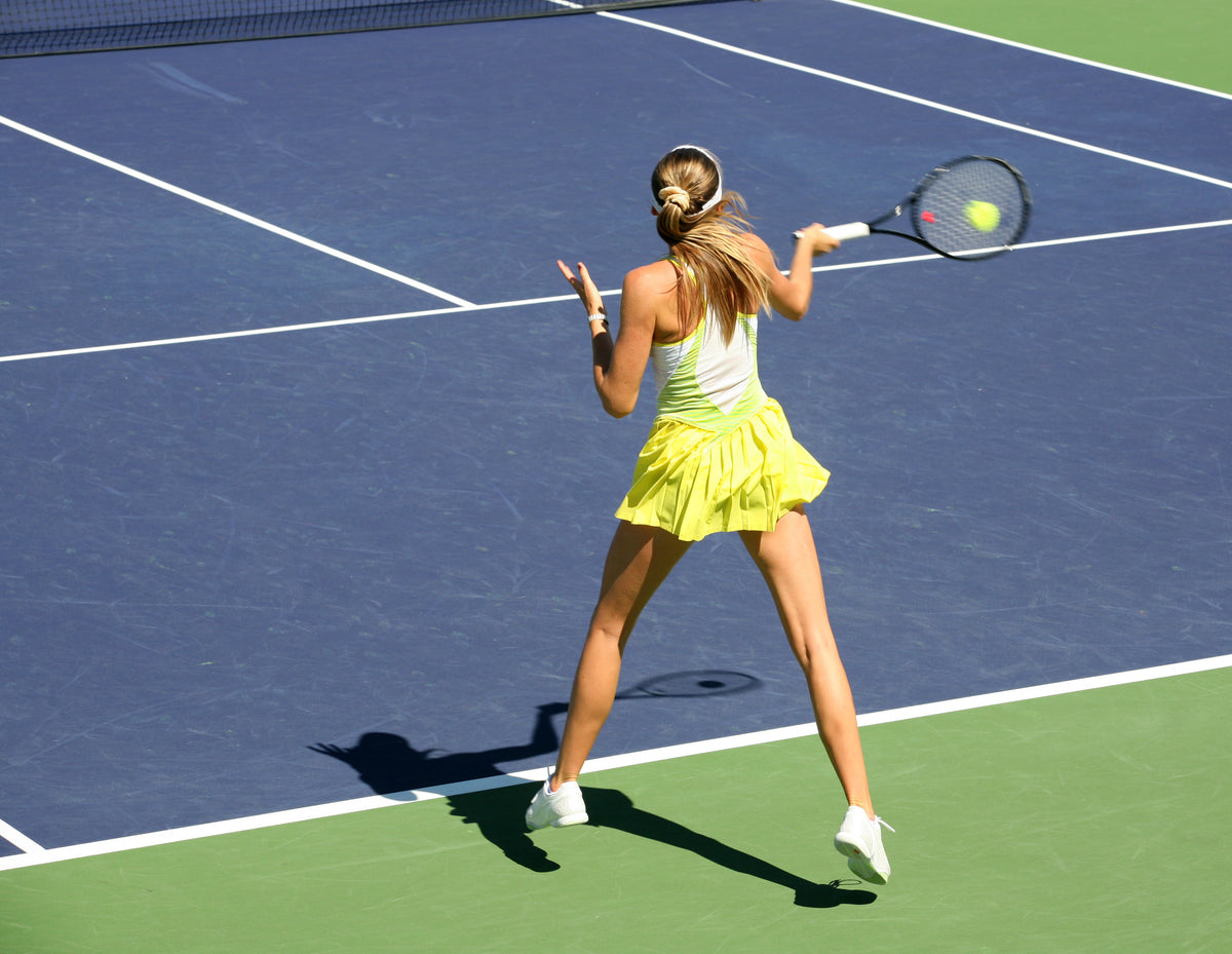 Woman hitting tennis ball