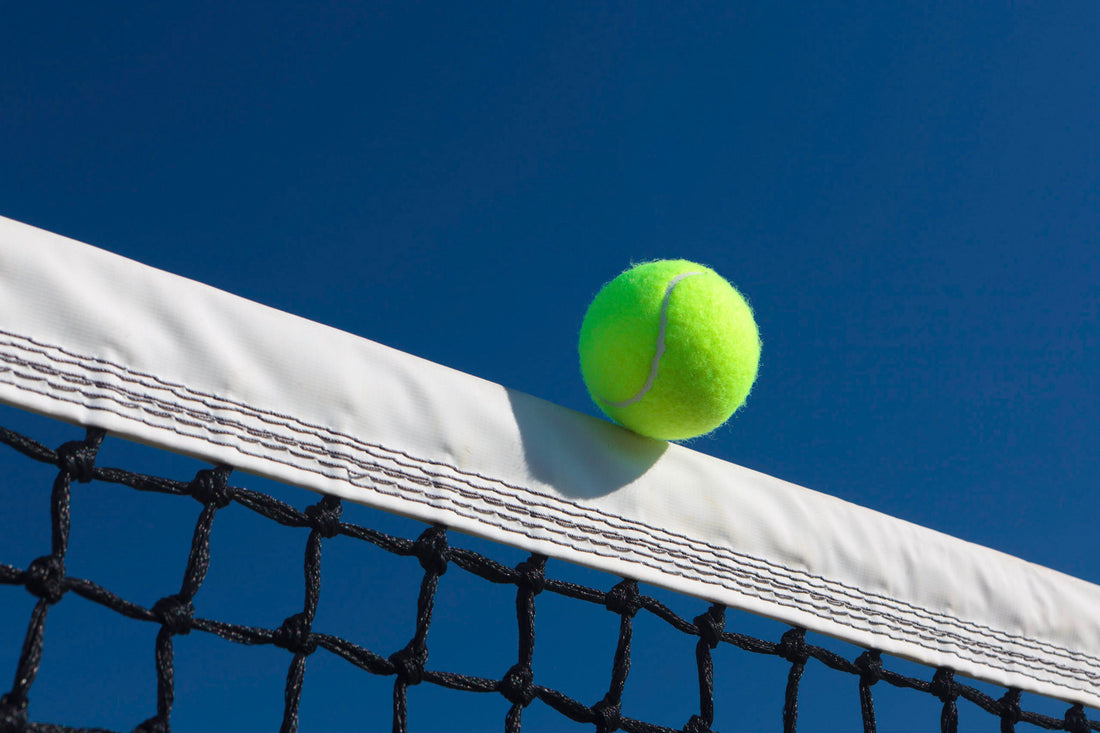 Tennis ball touching the net tape