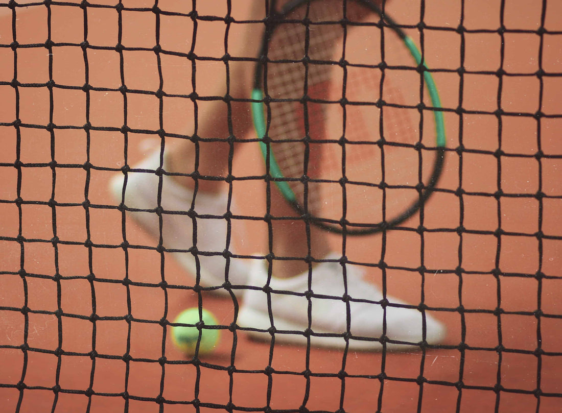 Person walking behind a tennis net