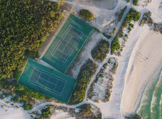 Two tennis courts next to the beach