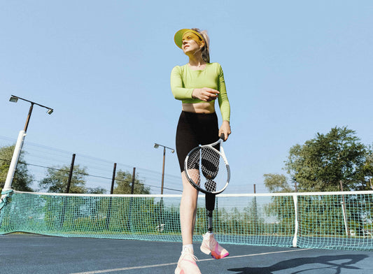 Women playing tennis, on blue court.