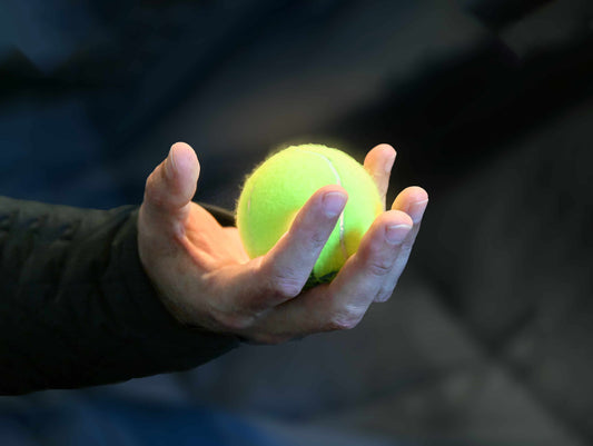 Tennis ball in someone's hand