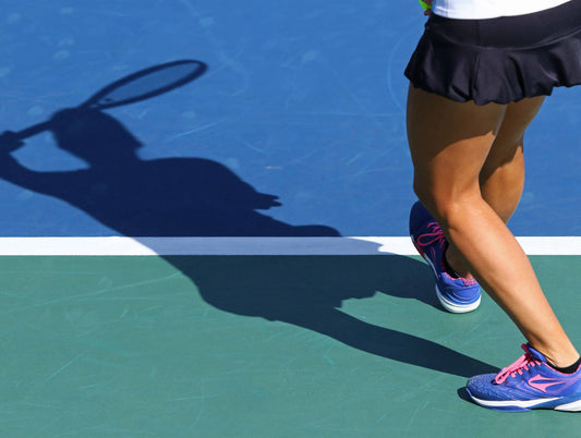 Closeup of tennis players legs while serving