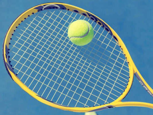 Tennis ball on tennis racquet
