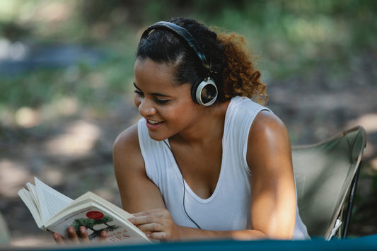 Woman reading a book looking very happy