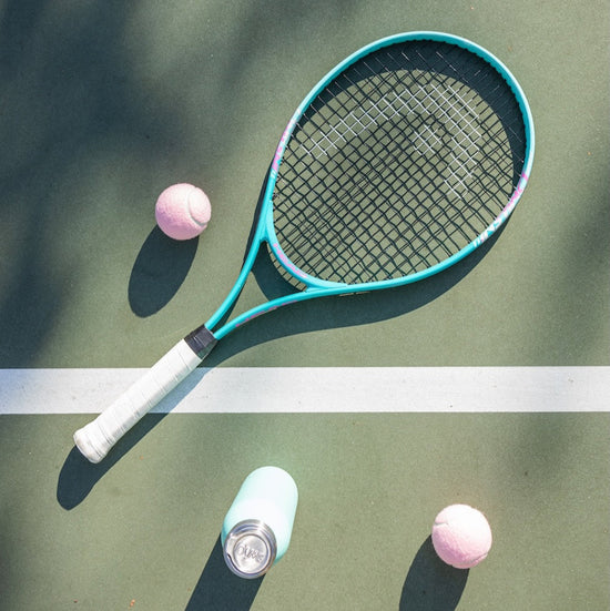Tennis racquet on a tennis court.