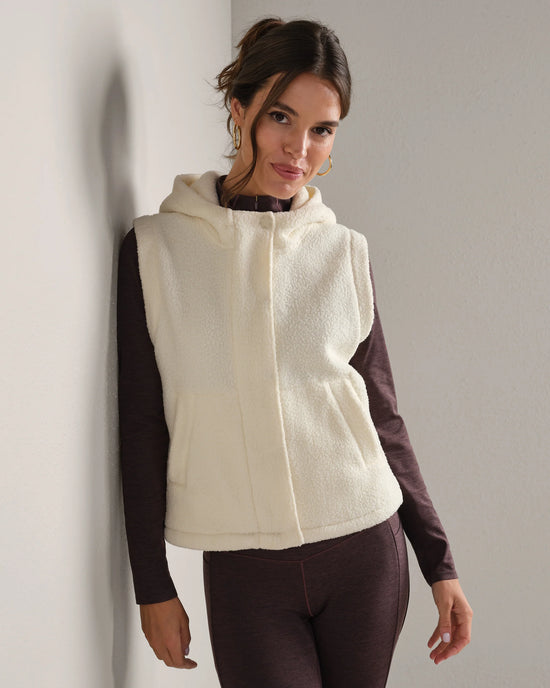 Woman wearing a white fleece vest.