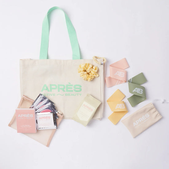 tennis tote bag with APRÈS logo, cosmetics, scrunchie, and colorful cards on a white background.