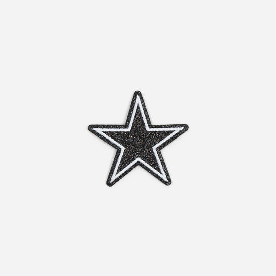 Black and white glittery star with an outline against a plain white background.