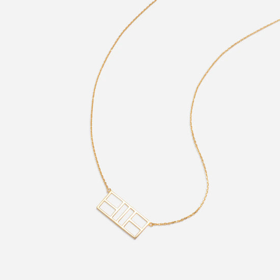 Gold necklace with a tennis court detail.