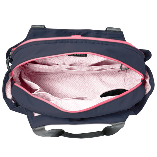 Open navy bag with pink interior and geometric pattern, showing compartments and handles.