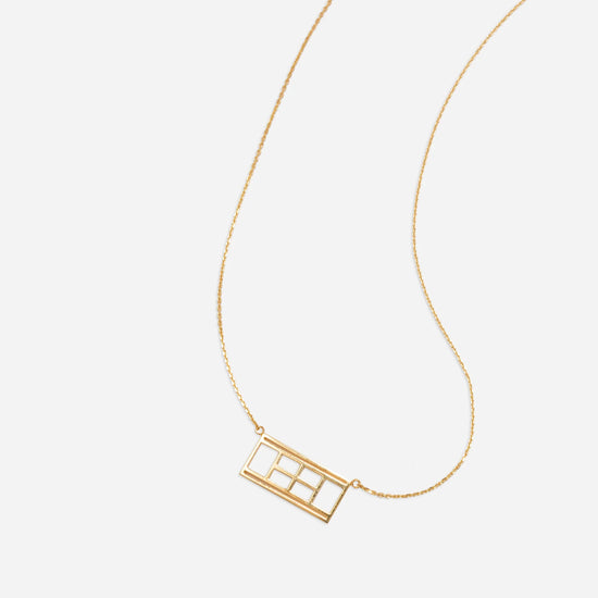 Gold necklace with tennis court detail.