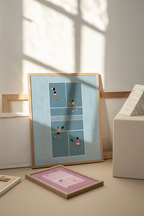 Framed tennis art print leaning against a wall, with shadow patterns and other frames around it.